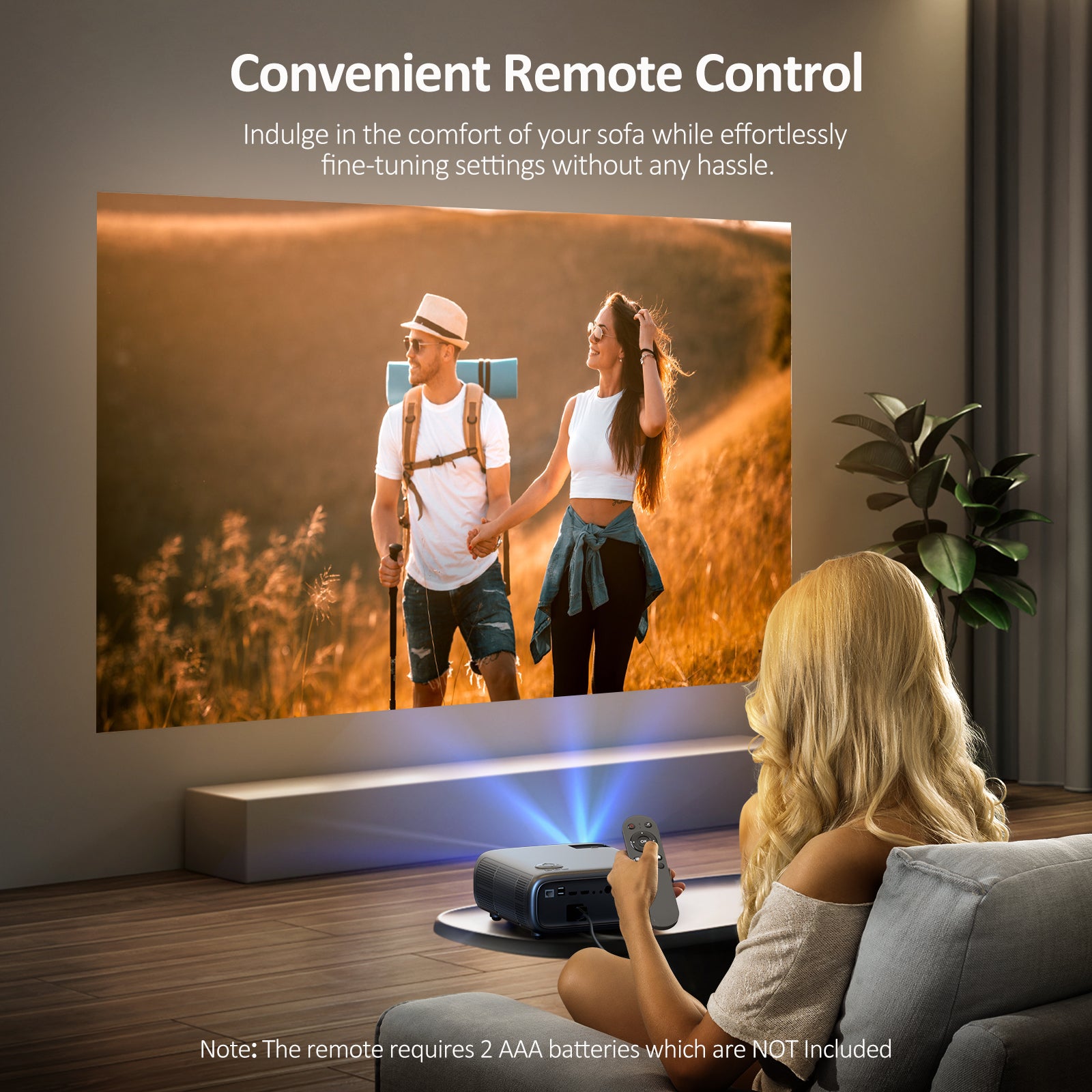 One person is sitting on the sofa, using the PJ40 remote control to watch a movie with the PJ40 projector.